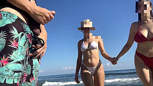 Exhibitionist voyeur flashes cock on public beach in front of two horny girls