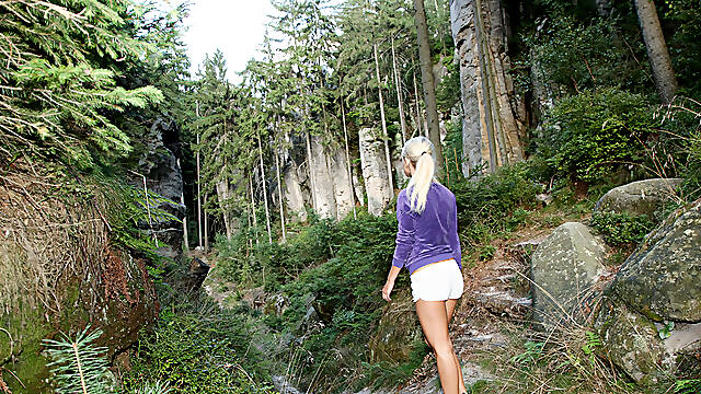 Blonde Teases Her Pussy on a Mossy Cliffside Trail