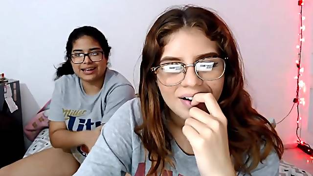 Two nerdy latinas playing with their pussies on cam